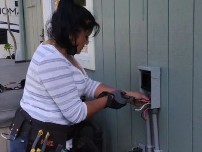 Licensed electrician wiring an exterior subpanel in East Caln