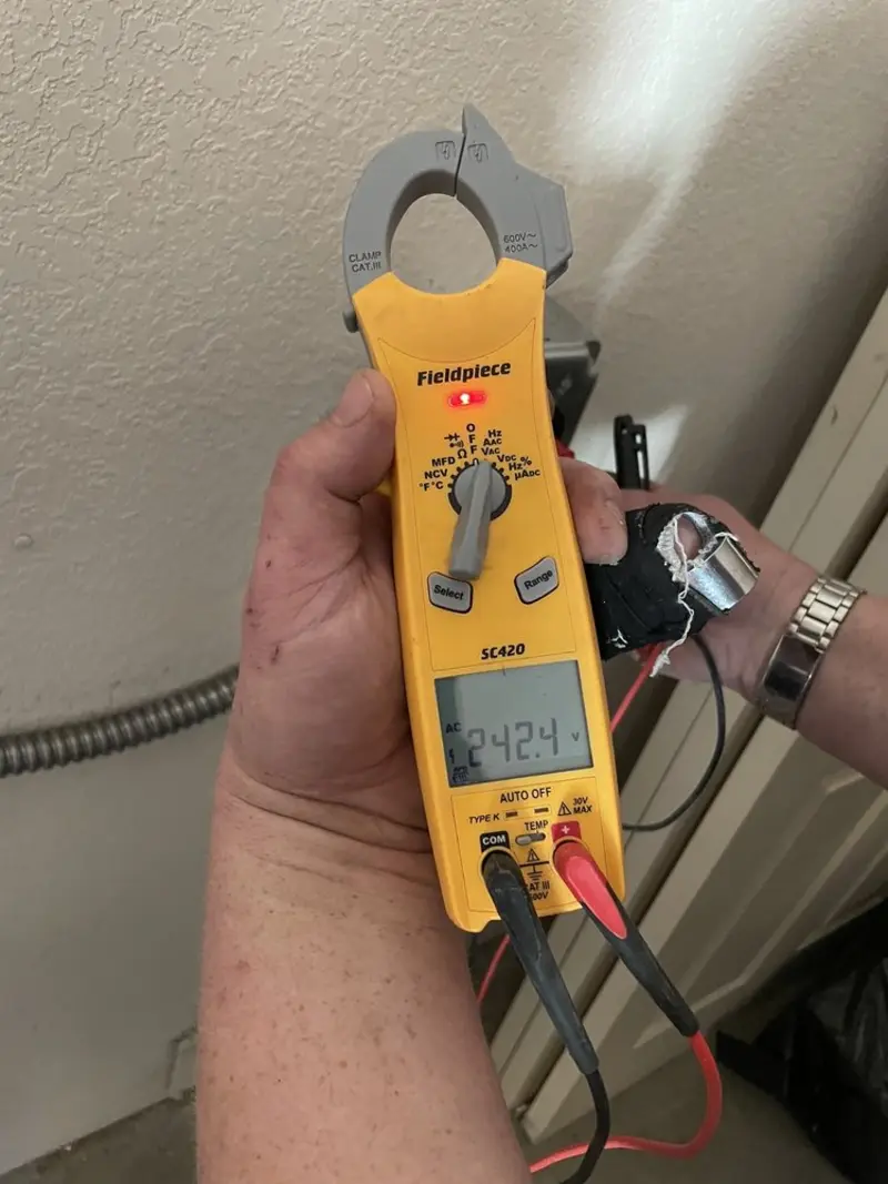 Voltage testing with clamp meter during Ceiling Fan Installation in East Caln